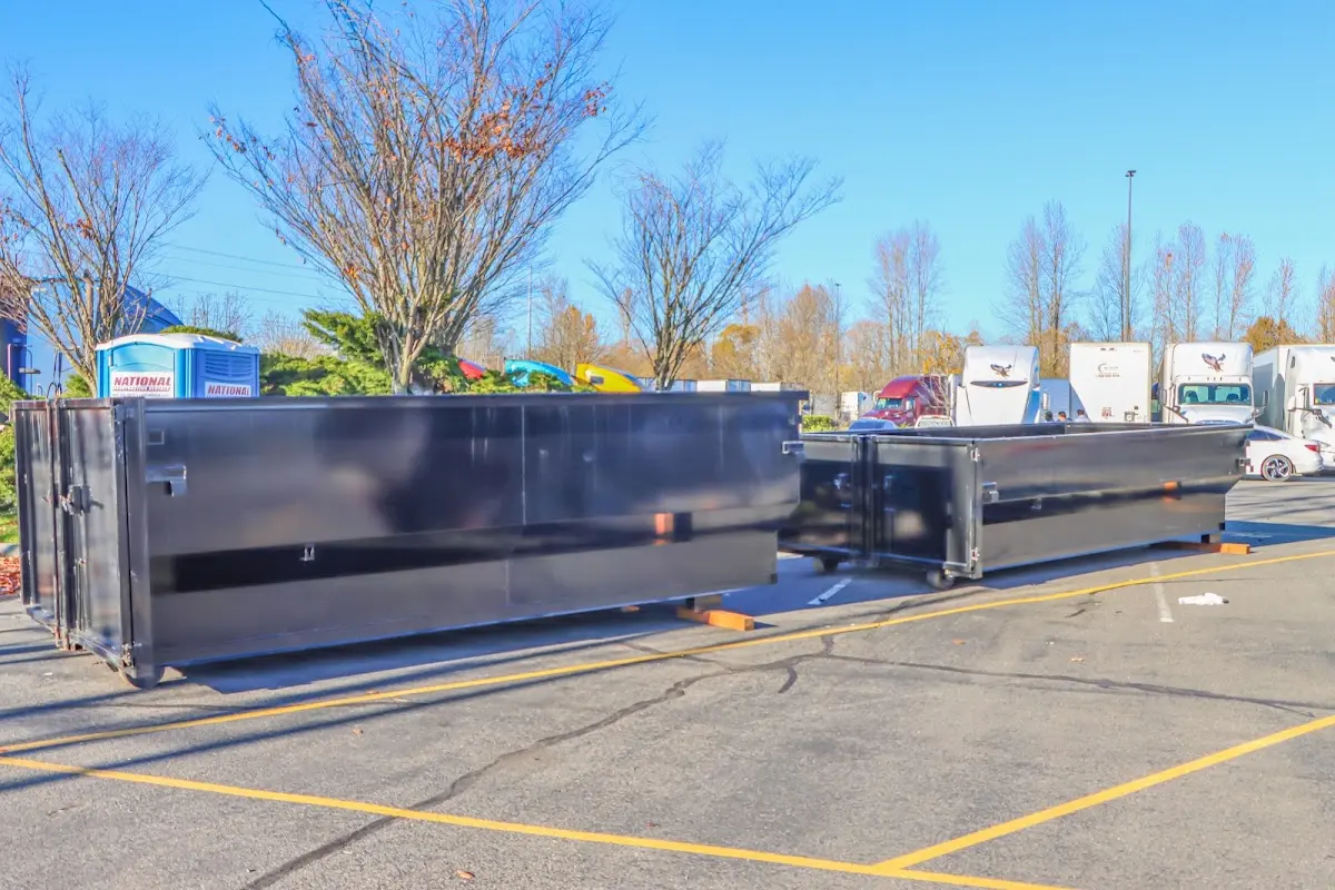 Professional dumpster rental service with roll-off container on residential driveway in Thermalito